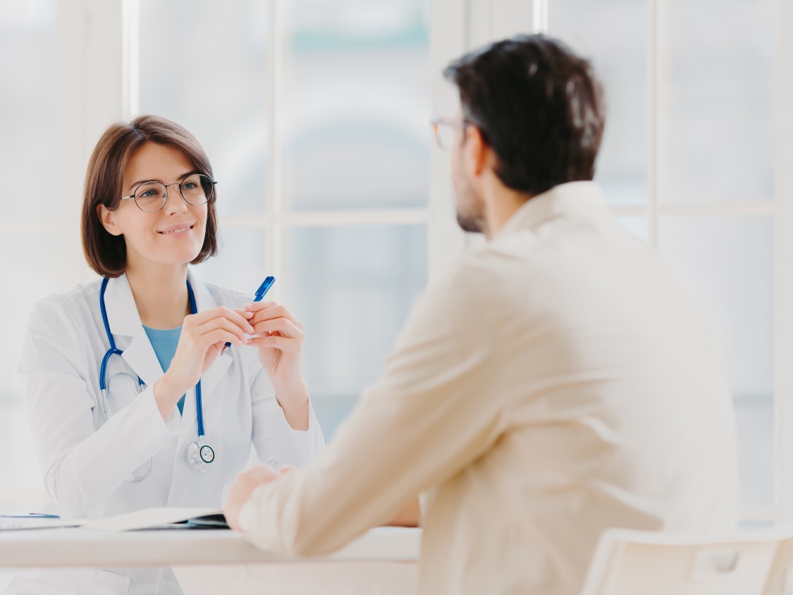 Pharmacist assisting customer at modern pharmacy counter